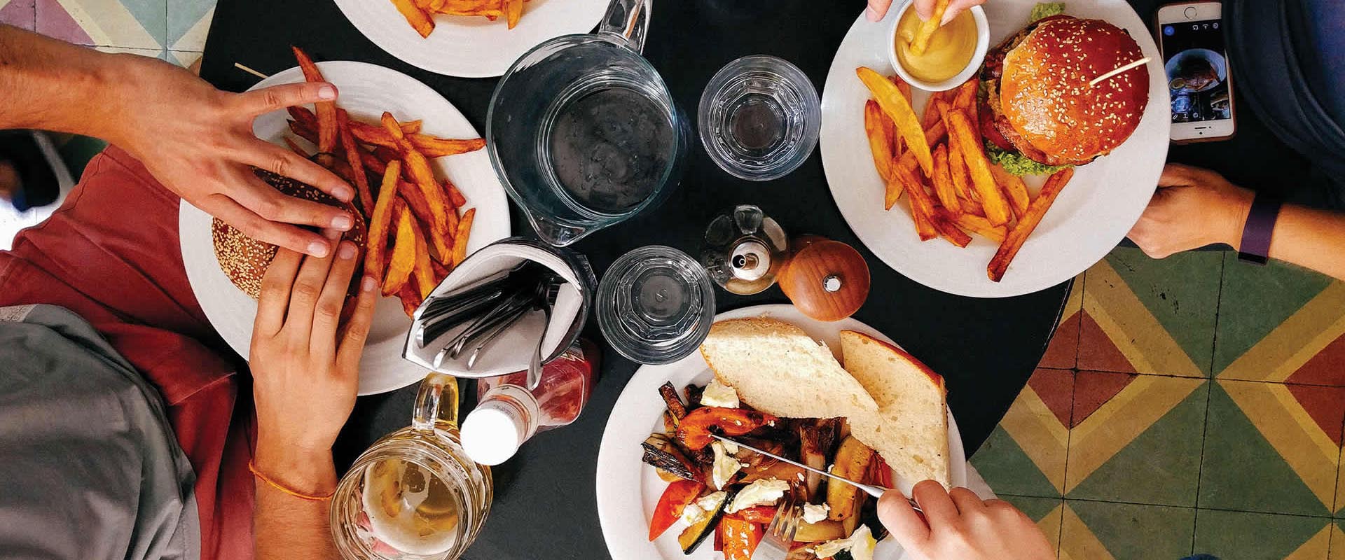 Table seen from the top with drinks and plates with food